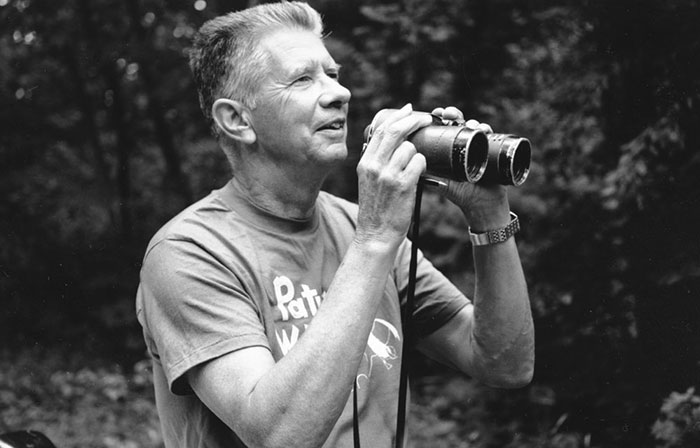 Robbins uses his binoculars. Photo by Barbara Dowell, courtesy USGS