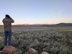 Click to view a larger image in a new tab or window Watching with binoculars so as not to disturb the Greater Sage Grouse Courtesy & Copyright Sue Salmon, Photographer